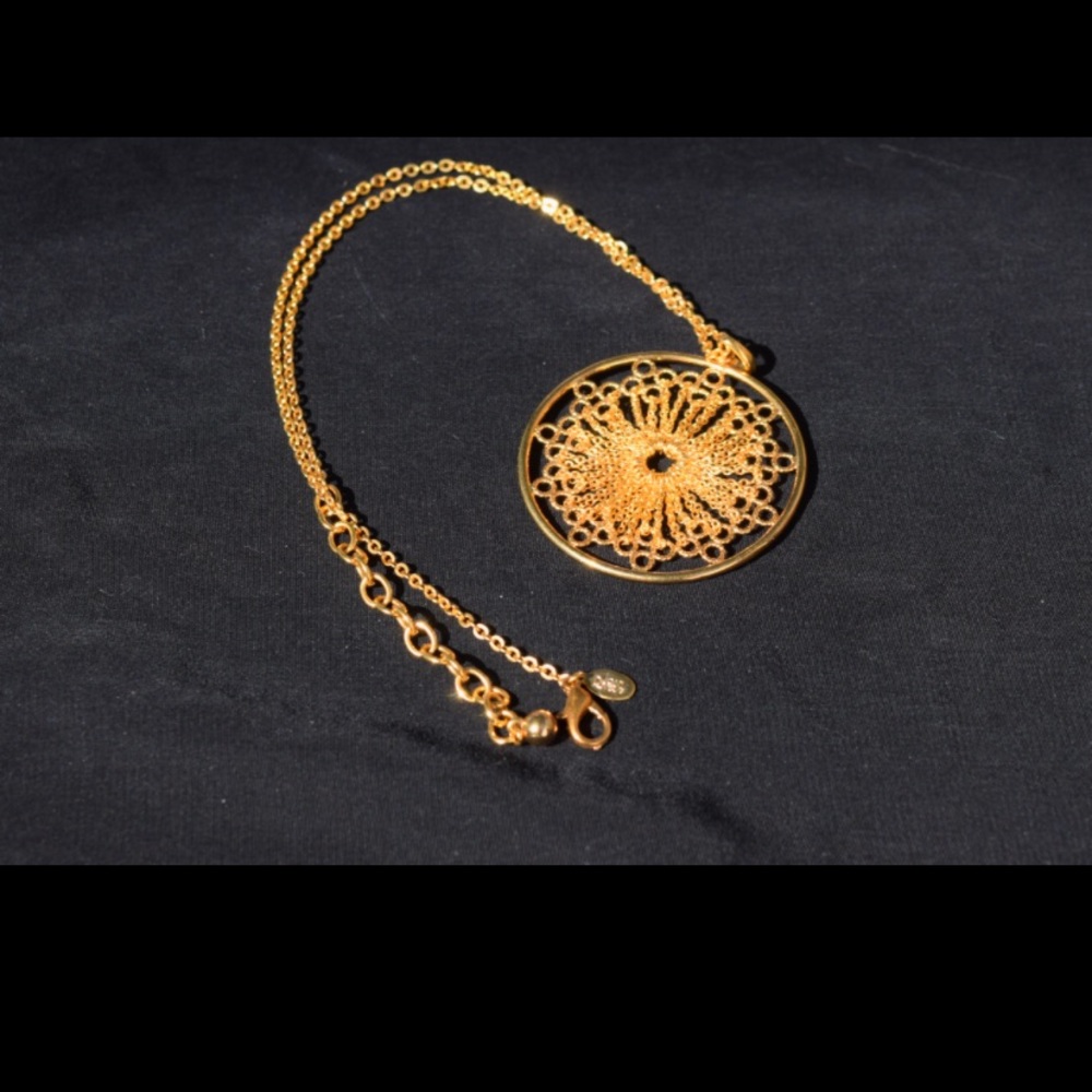 Joan Rivers filigree mandala pendant necklace.
